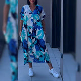 Elena™ | Blommig och elegant klänning med svepande siluett